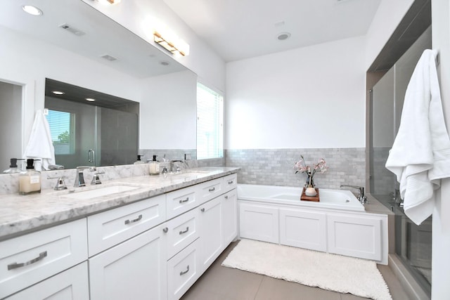 1822 Mcilhenny St Unit B, Houston, TX 77004 - full bathroom with double vanity, a garden tub, tile patterned floors, a wainscoted wall, and tile walls