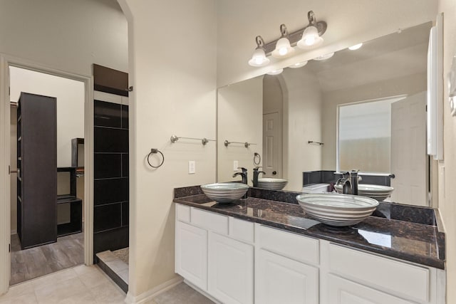 12906 Leafy Shores Dr, Houston, TX 77044 - full bathroom with a tile shower, double vanity, and tile patterned floors