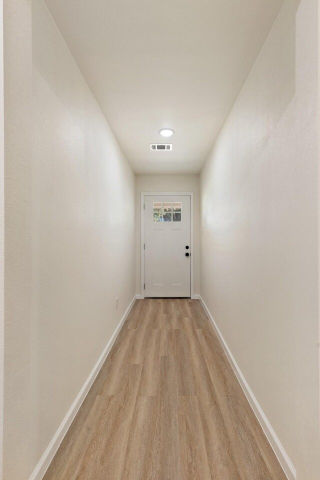 2801 Pickerton Dr, Deer Park, TX 77536 - doorway featuring light wood-style floors and baseboards