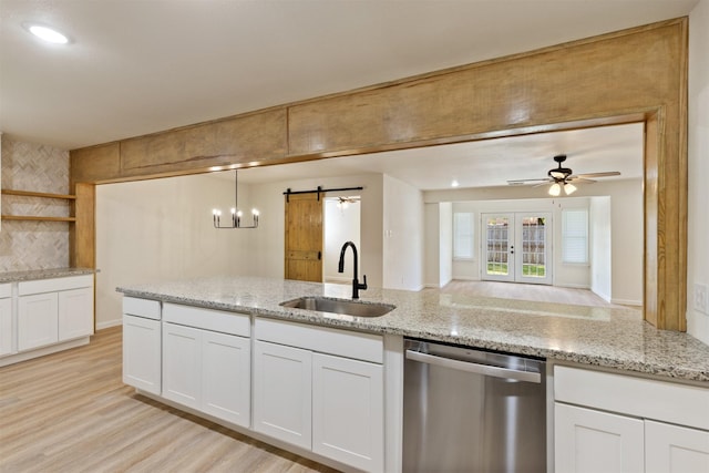 2801 Pickerton Dr, Deer Park, TX 77536 - kitchen with dishwasher, a sink, a barn door, open shelves, and white cabinets