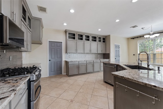 16503 Timberidge Ct, Cypress, TX 77429 - kitchen featuring stainless steel appliances, a sink, backsplash, gray cabinets, and recessed lighting