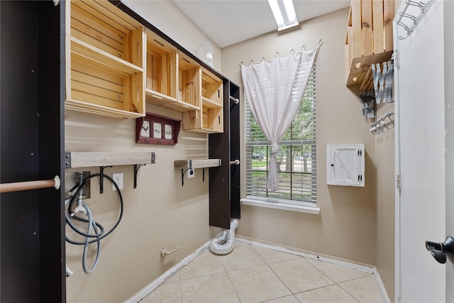 16503 Timberidge Ct, Cypress, TX 77429 - laundry room featuring tile patterned flooring, hookup for a washing machine, baseboards, and cabinet space