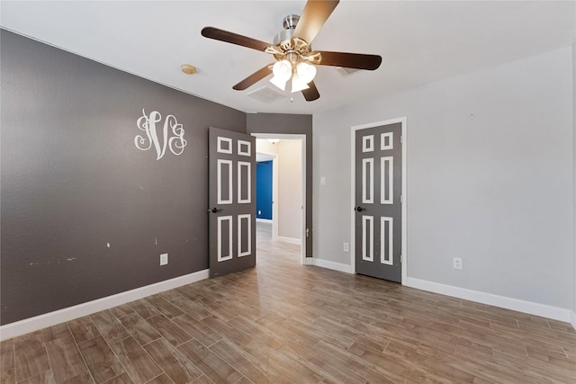 16503 Timberidge Ct, Cypress, TX 77429 - empty room featuring a ceiling fan, wood finished floors, baseboards, and a smoke detector