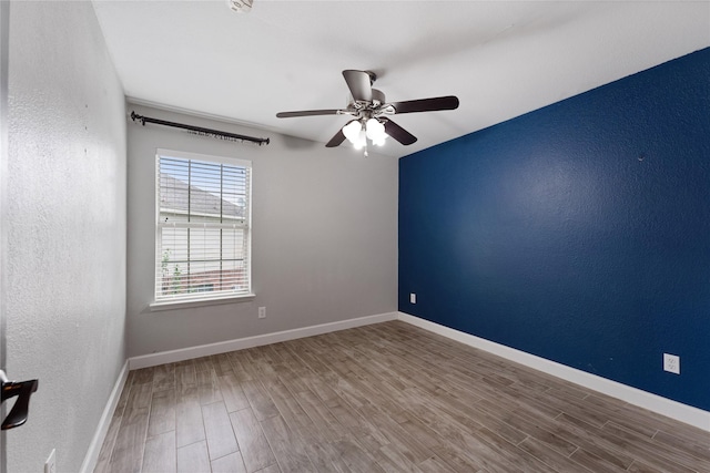 16503 Timberidge Ct, Cypress, TX 77429 - spare room with wood finished floors, a ceiling fan, baseboards, and a textured wall