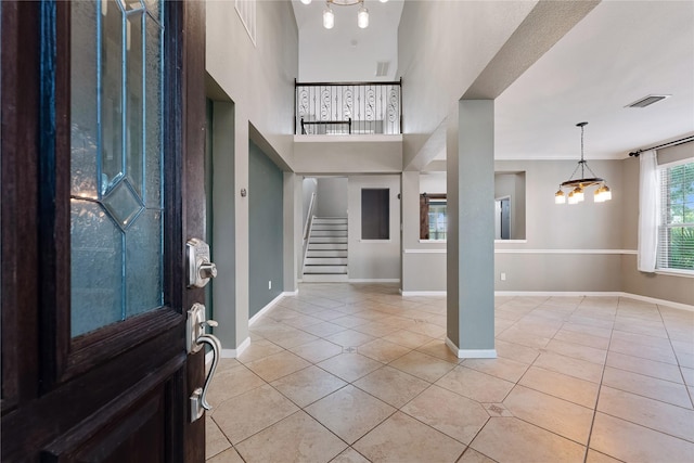 16503 Timberidge Ct, Cypress, TX 77429 - foyer entrance with light tile patterned floors, a chandelier, stairway, and baseboards