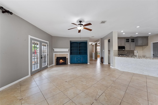 16503 Timberidge Ct, Cypress, TX 77429 - unfurnished living room with ceiling fan, light tile patterned floors, french doors, recessed lighting, and baseboards