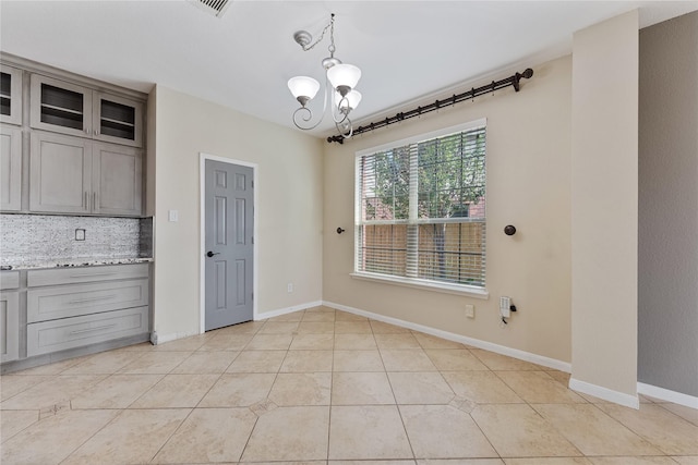 16503 Timberidge Ct, Cypress, TX 77429 - unfurnished dining area with a chandelier, light tile patterned floors, and baseboards