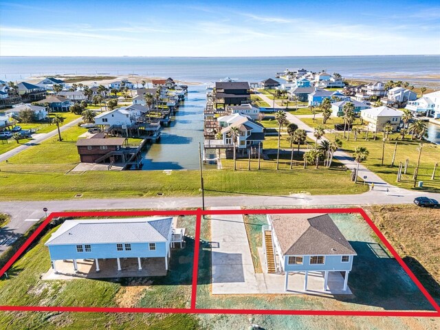 3903 2nd St, Galveston, TX 77554 - aerial perspective of suburban area with property parcel outlined and a large body of water