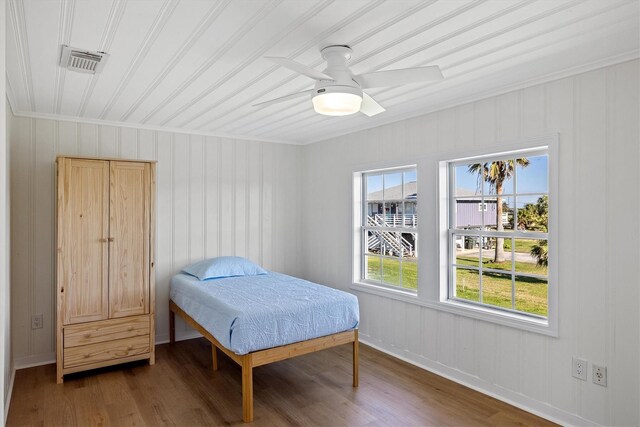 3903 2nd St, Galveston, TX 77554 - bedroom with crown molding, wood finished floors, ceiling fan, and baseboards