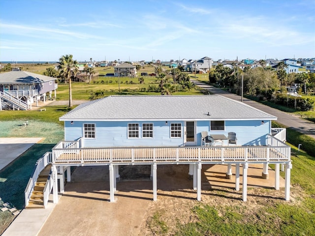 3903 2nd St, Galveston, TX 77554 - view of front of home with stairs, a shingled roof, a residential view, and a carport