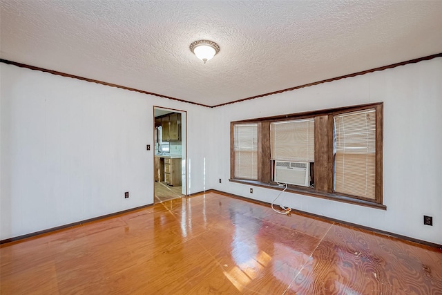 31002 Misty Meadow Dr, Magnolia, TX 77354 - spare room featuring ornamental molding, wood finished floors, a textured ceiling, baseboards, and cooling unit