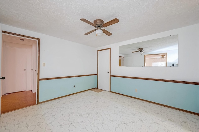 31002 Misty Meadow Dr, Magnolia, TX 77354 - unfurnished room with ceiling fan, baseboards, tile patterned floors, and a textured ceiling