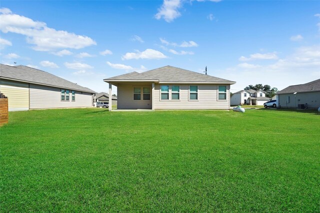 6502 Blimp Base Blvd, Hitchcock, TX 77563 - back of property with a yard and central air condition unit