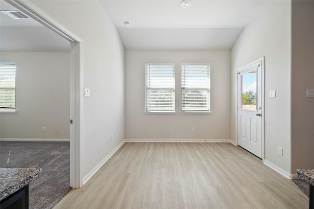 6502 Blimp Base Blvd, Hitchcock, TX 77563 - unfurnished room featuring healthy amount of natural light, light wood-style floors, baseboards, and a smoke detector