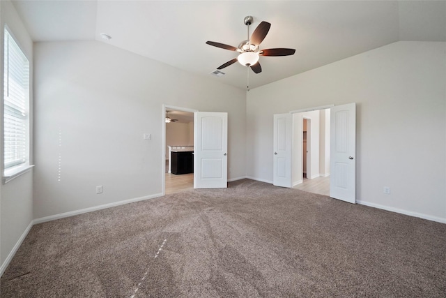 6502 Blimp Base Blvd, Hitchcock, TX 77563 - unfurnished bedroom with vaulted ceiling, light carpet, baseboards, and a ceiling fan