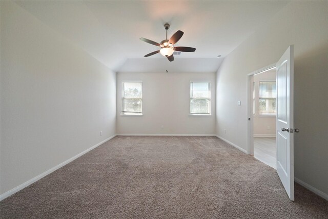 6502 Blimp Base Blvd, Hitchcock, TX 77563 - spare room with a ceiling fan, vaulted ceiling, healthy amount of natural light, and light carpet