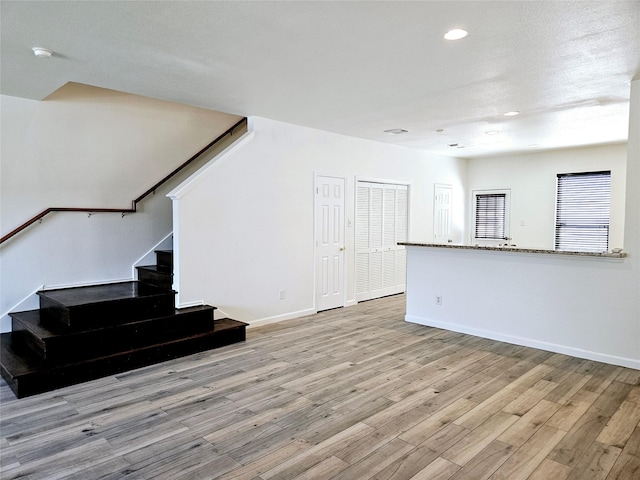 8039 Ellinger Ln, Houston, TX 77040 - unfurnished living room featuring stairs, wood finished floors, recessed lighting, and baseboards