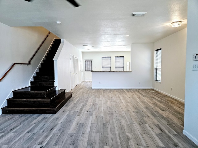 8039 Ellinger Ln, Houston, TX 77040 - unfurnished living room featuring wood finished floors, stairs, and baseboards