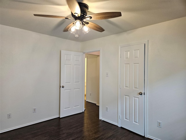 8039 Ellinger Ln, Houston, TX 77040 - unfurnished bedroom with dark wood-style flooring, baseboards, and a ceiling fan