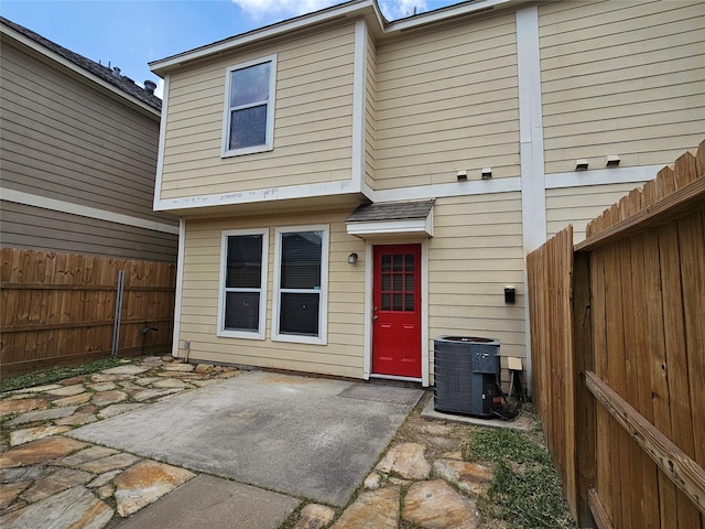 8039 Ellinger Ln, Houston, TX 77040 - back of house with central AC, a patio area, and a fenced backyard