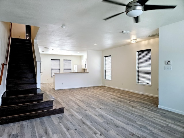 8039 Ellinger Ln, Houston, TX 77040 - unfurnished living room featuring stairs, ceiling fan, light wood-style floors, and baseboards