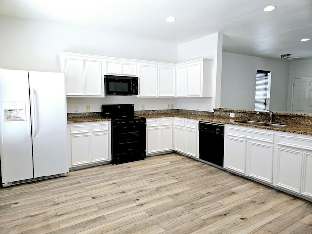 8039 Ellinger Ln, Houston, TX 77040 - kitchen with black appliances, a sink, dark stone countertops, recessed lighting, and white cabinetry