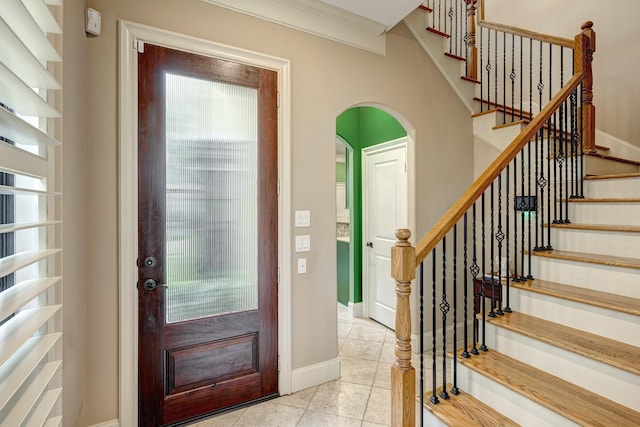 2306 Mcduffie St, Houston, TX 77019 - entryway featuring stairs, light tile patterned flooring, arched walkways, and baseboards