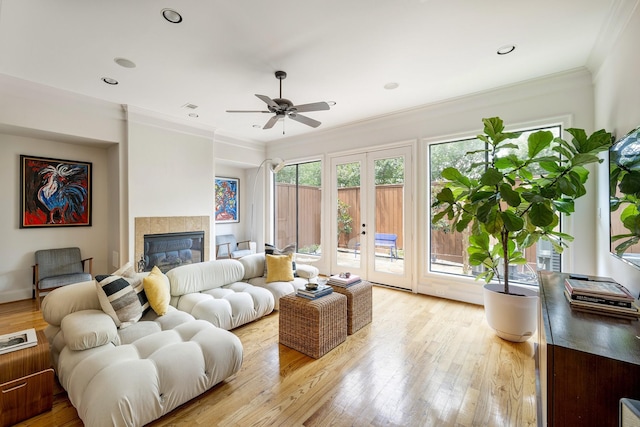 2306 Mcduffie St, Houston, TX 77019 - living room with french doors, ceiling fan, light wood-type flooring, crown molding, and a fireplace