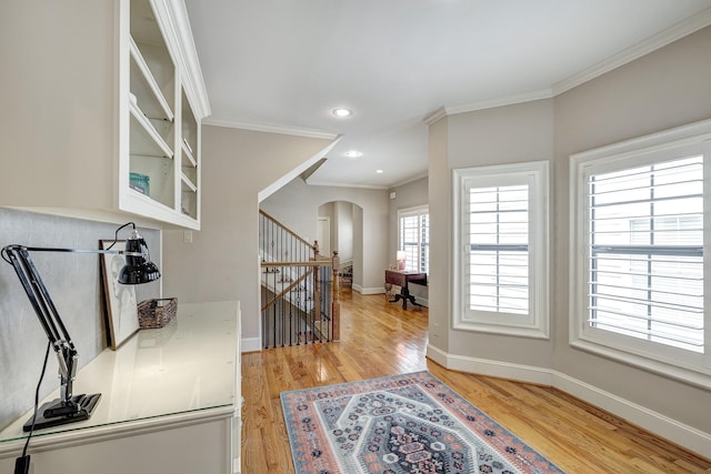 2306 Mcduffie St, Houston, TX 77019 - entryway featuring arched walkways, ornamental molding, light wood finished floors, baseboards, and recessed lighting