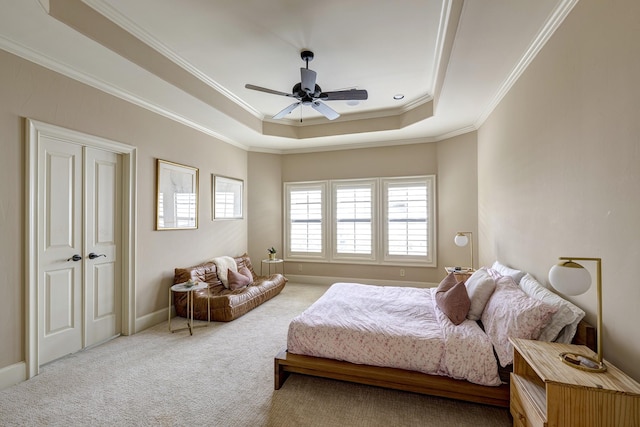 2306 Mcduffie St, Houston, TX 77019 - carpeted bedroom featuring multiple windows, a raised ceiling, ornamental molding, and a ceiling fan
