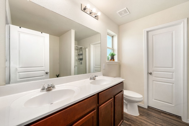 14619 Jasper Stream Ct, Houston, TX 77069 - bathroom featuring toilet, double vanity, wood finished floors, and a shower