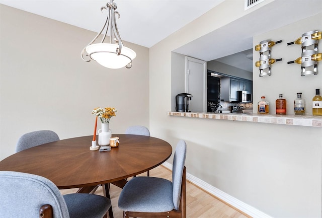 2011 Winrock Blvd Unit 172, Houston, TX 77057 - dining area with baseboards and light wood-style flooring