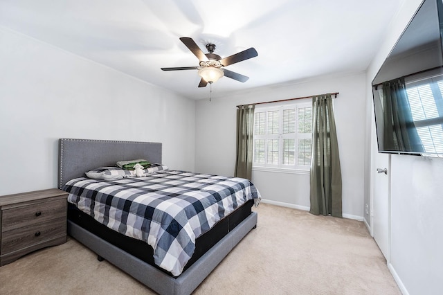 2011 Winrock Blvd Unit 172, Houston, TX 77057 - bedroom with light colored carpet, baseboards, and a ceiling fan