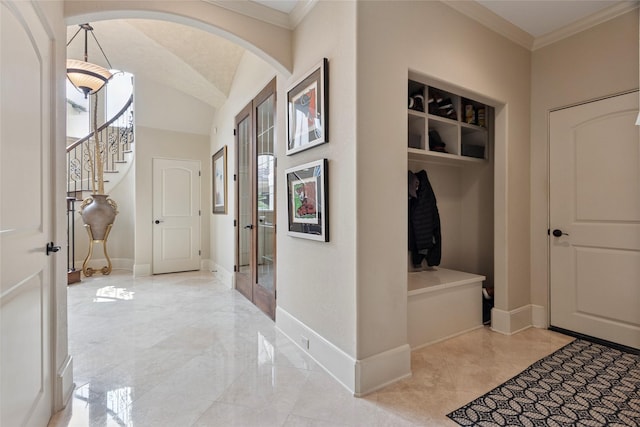 5520 Mcculloch Cir, Houston, TX 77056 - mudroom with crown molding, arched walkways, baseboards, light marble finish flooring, and lofted ceiling