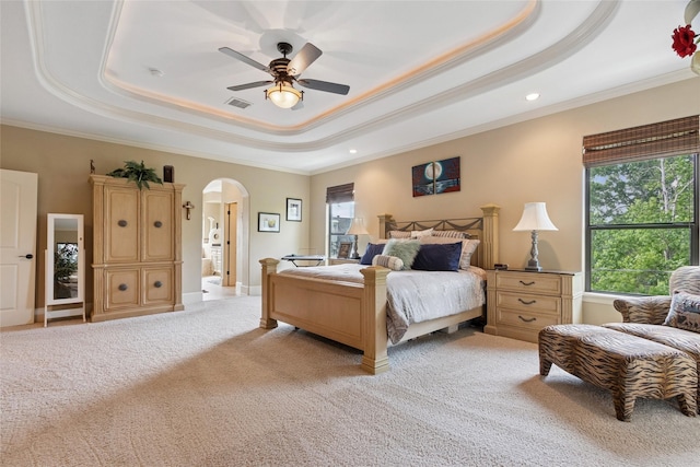 5520 Mcculloch Cir, Houston, TX 77056 - bedroom featuring a tray ceiling, arched walkways, crown molding, light colored carpet, and recessed lighting