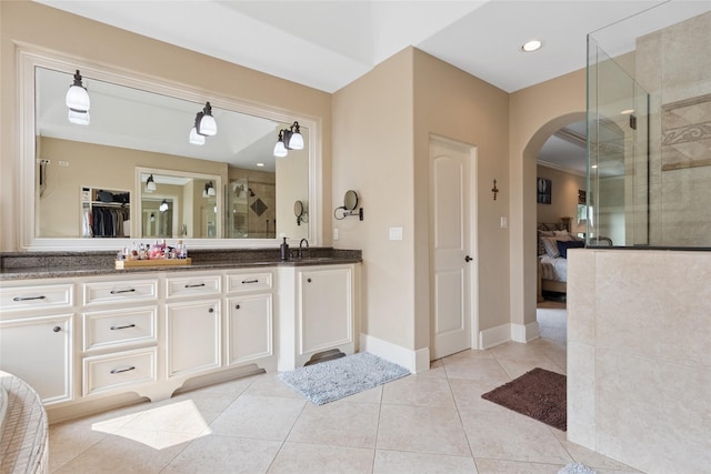5520 Mcculloch Cir, Houston, TX 77056 - bathroom featuring ensuite bathroom, double vanity, a shower stall, tile patterned floors, and a spacious closet