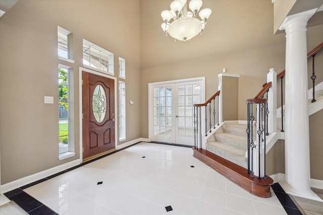42 Stalybridge St, Sugar Land, TX 77479 - entryway with plenty of natural light, ornate columns, a chandelier, stairway, and a towering ceiling