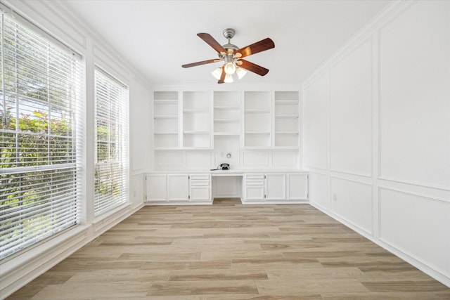 42 Stalybridge St, Sugar Land, TX 77479 - unfurnished office with built in study area, plenty of natural light, a ceiling fan, a decorative wall, and built in features