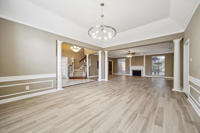 42 Stalybridge St, Sugar Land, TX 77479 - unfurnished living room featuring ornamental molding, a fireplace, light wood-type flooring, a chandelier, and stairway