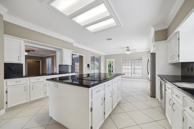42 Stalybridge St, Sugar Land, TX 77479 - kitchen featuring a ceiling fan, appliances with stainless steel finishes, a kitchen island, backsplash, and crown molding