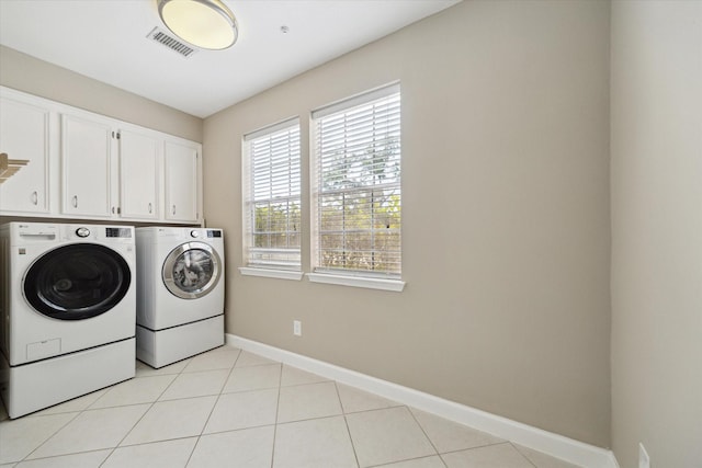 42 Stalybridge St, Sugar Land, TX 77479 - laundry room featuring washer and clothes dryer, cabinet space, baseboards, and light tile patterned floors