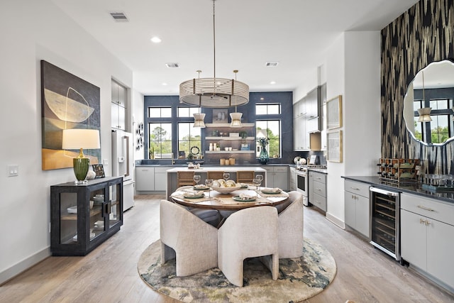 1720 Sedola Ln, Houston, TX 77055 - dining space featuring wine cooler, light wood finished floors, and recessed lighting