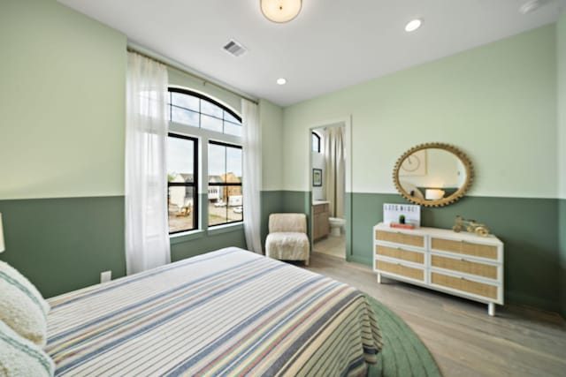 1720 Sedola Ln, Houston, TX 77055 - bedroom featuring wood finished floors, ensuite bath, baseboards, and recessed lighting