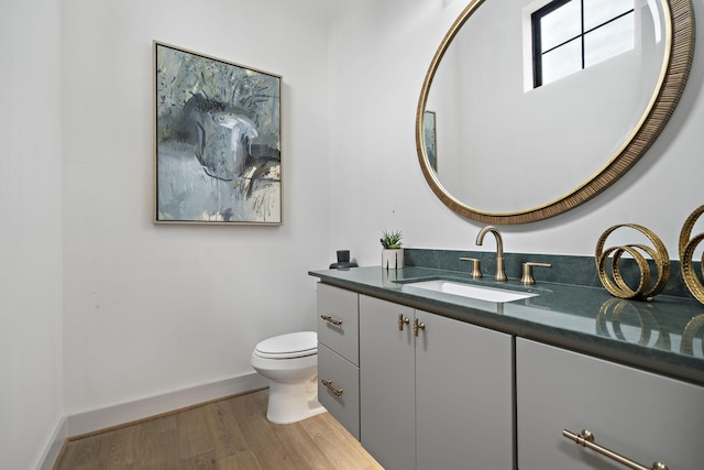 1720 Sedola Ln, Houston, TX 77055 - bathroom featuring vanity, toilet, wood finished floors, and baseboards