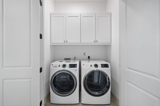 1720 Sedola Ln, Houston, TX 77055 - laundry room with washer and clothes dryer, cabinet space, and baseboards