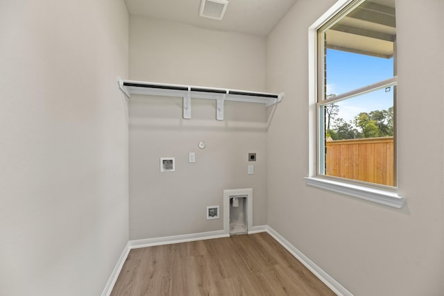 18810 Lucas Michael Way, New Caney, TX 77357 - laundry room with electric dryer hookup, wood finished floors, baseboards, and gas dryer hookup