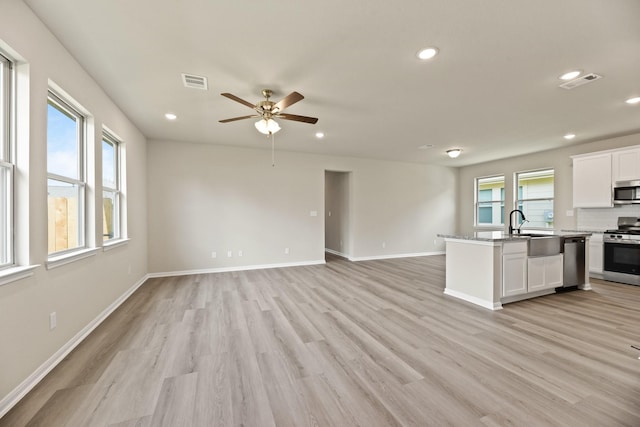 18810 Lucas Michael Way, New Caney, TX 77357 - kitchen featuring appliances with stainless steel finishes, a sink, open floor plan, and recessed lighting