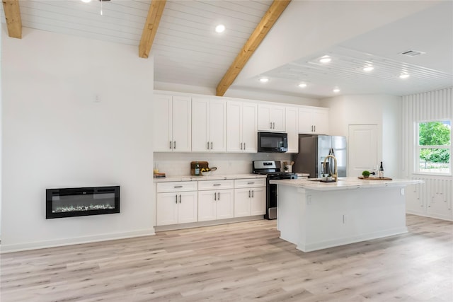 4014 Linder St, Houston, TX 77026 - kitchen featuring stainless steel appliances, white cabinets, a center island with sink, recessed lighting, and tasteful backsplash