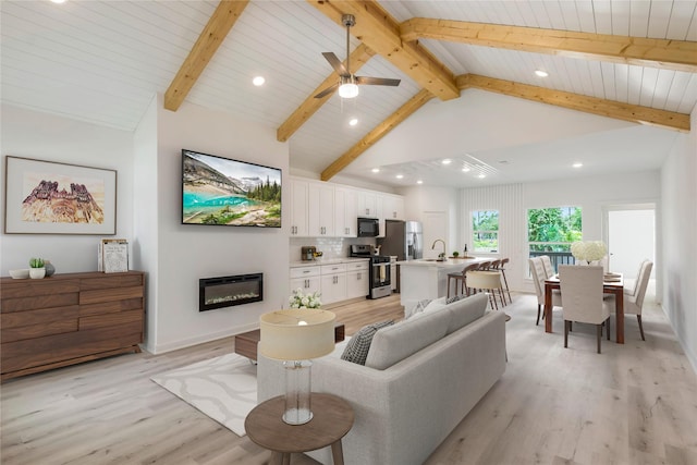 4014 Linder St, Houston, TX 77026 - living room featuring a glass covered fireplace, light wood-style floors, recessed lighting, wood ceiling with exposed beams, and high vaulted ceiling