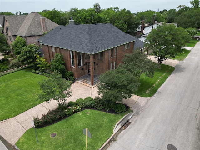 4900 Willow St, Bellaire, TX 77401 - ranch-style home featuring brick siding, a front yard, a shingled roof, and a chimney
